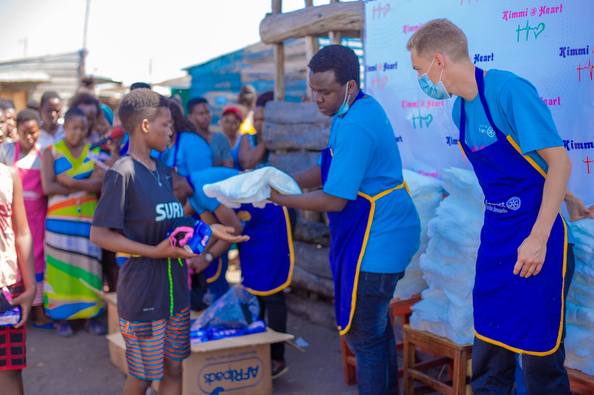 Volunteers distributing reusable sanitary towels to youth on Kimi Island