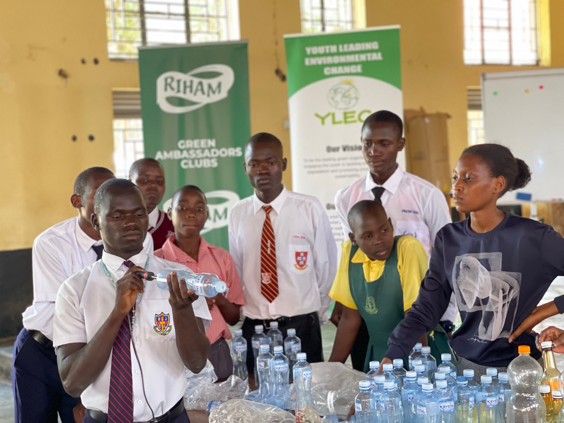 Facilitator demonstrating plastic bottle upcycling to Green Ambassadors students