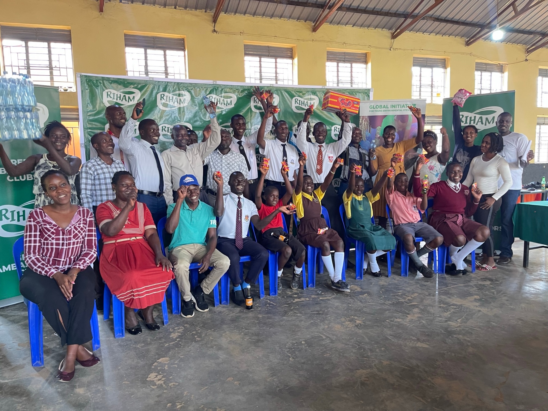 Riham Green Ambassadors Club project — celebratory group photo with students, teachers and partners at a Gulu City school session